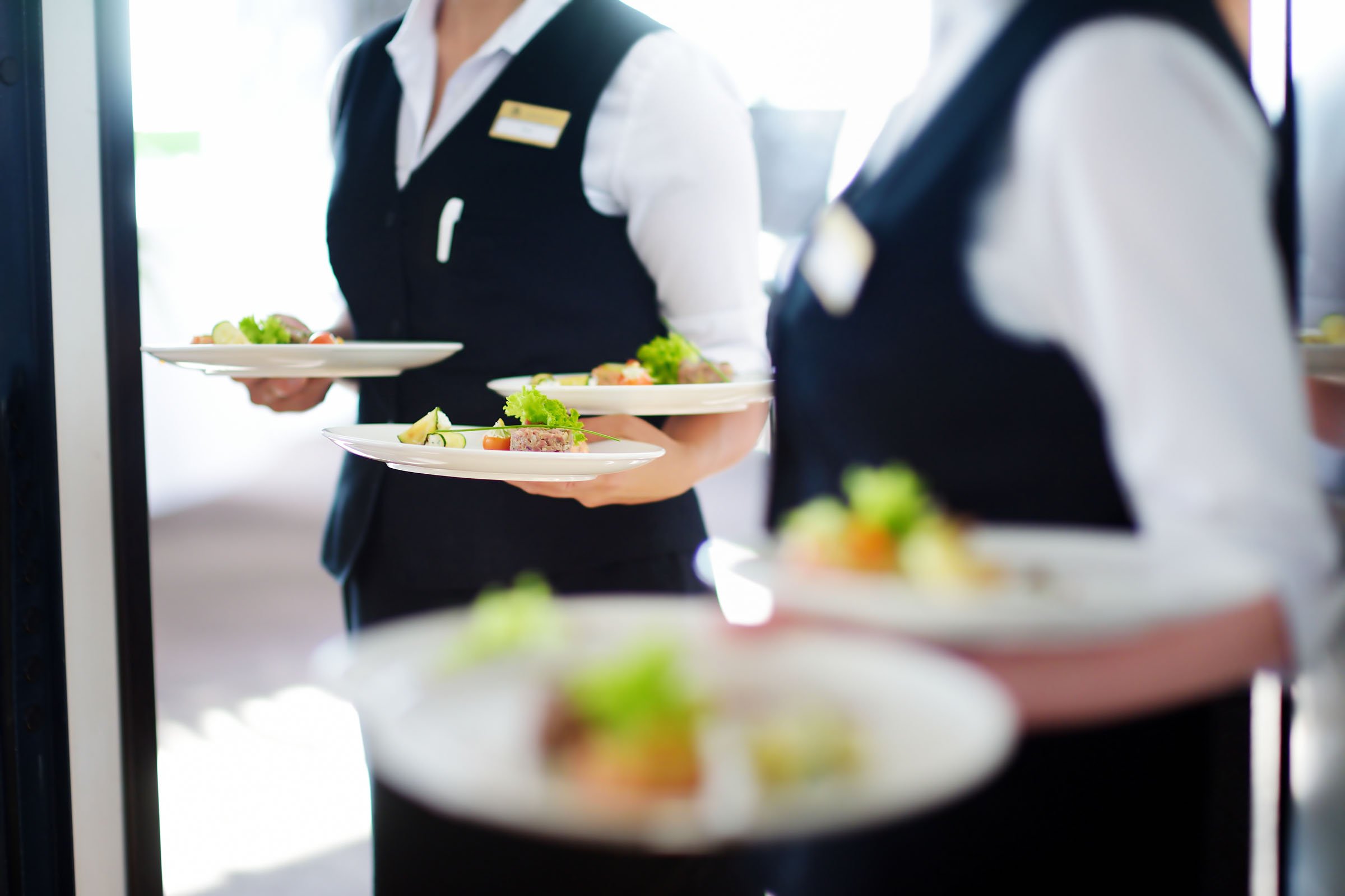 Servers carrying healthy plates of food